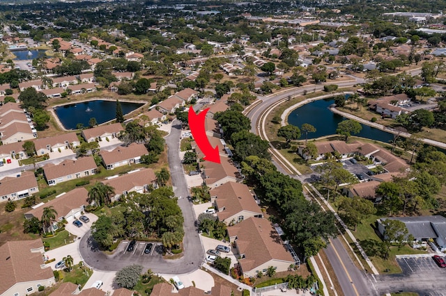 birds eye view of property featuring a water view and a residential view