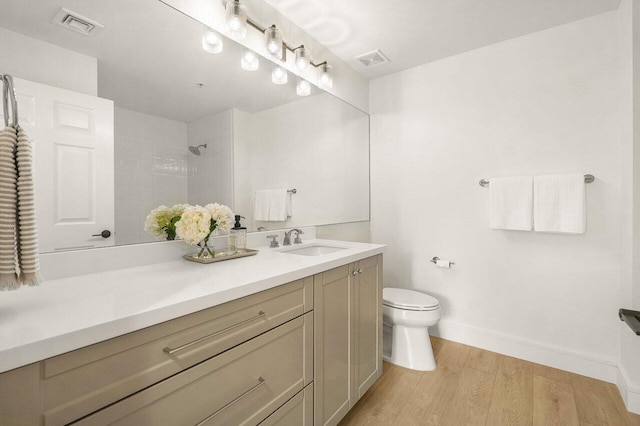 720 S Sapodilla Ave Unit 105, West Palm Beach, FL 33401 - full bath with toilet, wood finished floors, baseboards, vanity, and a tile shower
