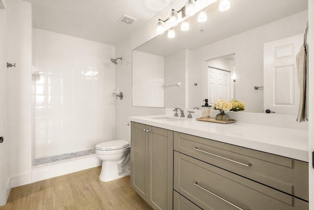 720 S Sapodilla Ave Unit 105, West Palm Beach, FL 33401 - bathroom with toilet, vanity, wood finished floors, and a tile shower