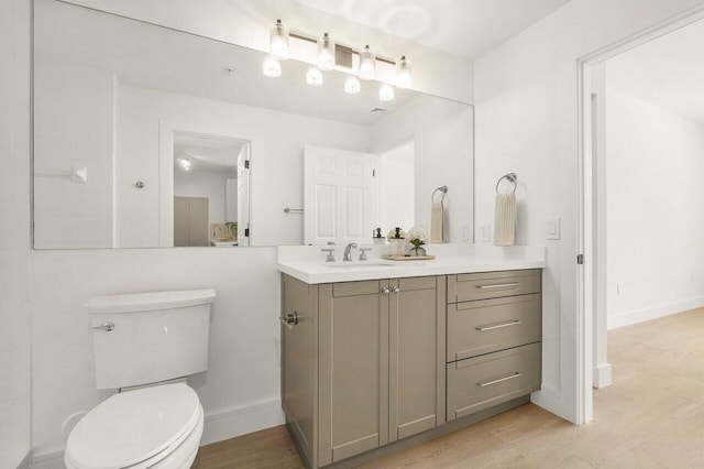 720 S Sapodilla Ave Unit 105, West Palm Beach, FL 33401 - bathroom featuring vanity, toilet, and baseboards