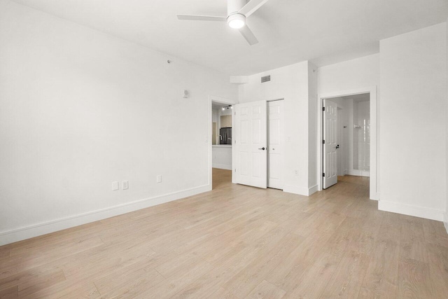 720 S Sapodilla Ave Unit 105, West Palm Beach, FL 33401 - unfurnished bedroom featuring light wood finished floors, baseboards, connected bathroom, a closet, and ceiling fan