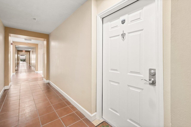 720 S Sapodilla Ave Unit 105, West Palm Beach, FL 33401 - corridor with dark tile patterned flooring and baseboards
