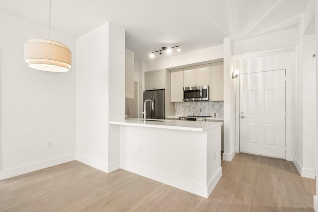 720 S Sapodilla Ave Unit 105, West Palm Beach, FL 33401 - kitchen with stainless steel appliances, light countertops, and light wood-style flooring