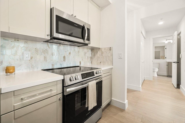 720 S Sapodilla Ave Unit 105, West Palm Beach, FL 33401 - kitchen featuring appliances with stainless steel finishes, light countertops, and baseboards
