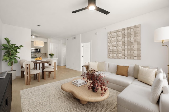 720 S Sapodilla Ave Unit 105, West Palm Beach, FL 33401 - living area with light wood-style floors and ceiling fan