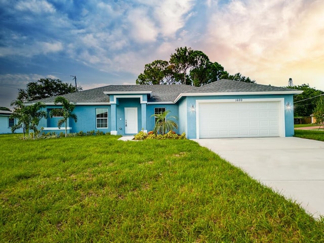 single story home with a front yard, stucco siding, driveway, and an attached garage