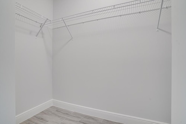 spacious closet with light wood-style floors