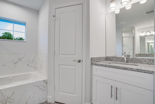 bathroom featuring vanity, marble finish floor, visible vents, a marble finish shower, and a garden tub