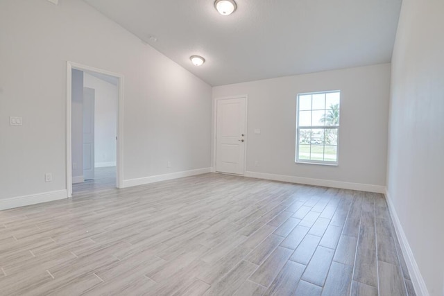 unfurnished room featuring baseboards and light wood-style floors