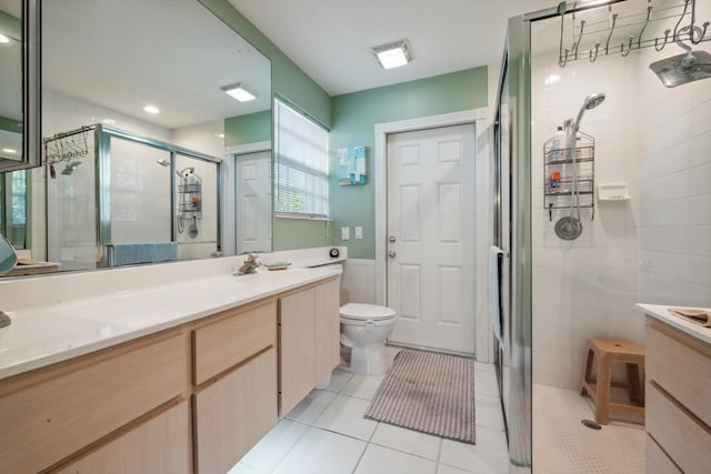 full bathroom with tile patterned flooring, vanity, toilet, tile walls, and a stall shower
