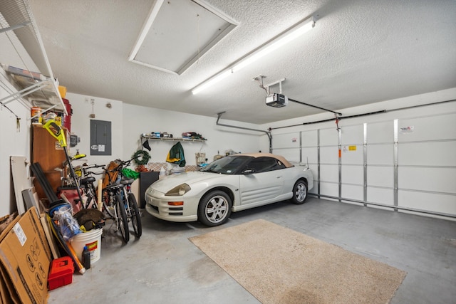 garage with a garage door opener and electric panel