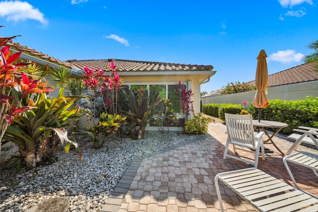 view of patio / terrace with outdoor dining area and a sunroom