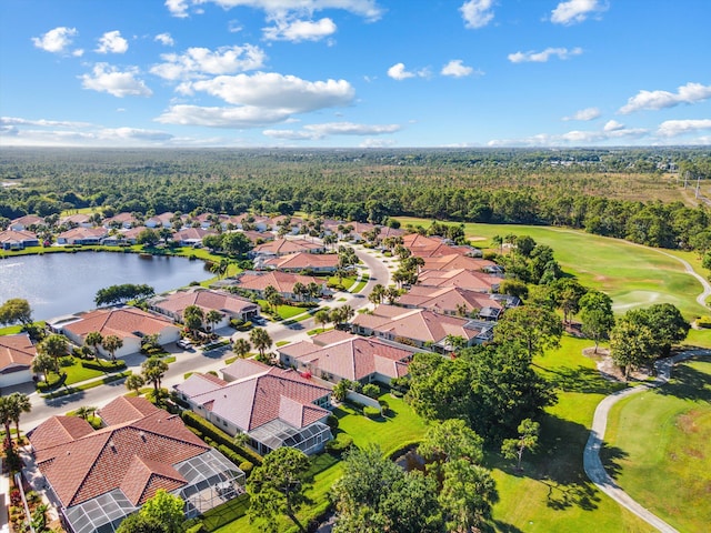 aerial view with a wooded view, a water view, golf course view, and a residential view