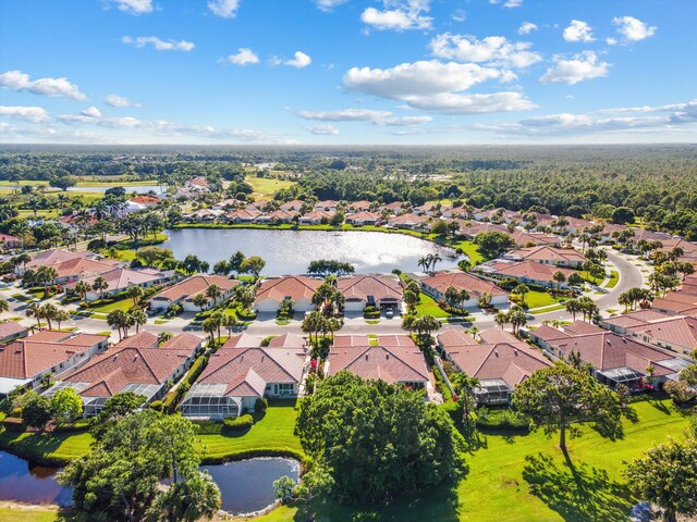 birds eye view of property featuring a water view and a residential view