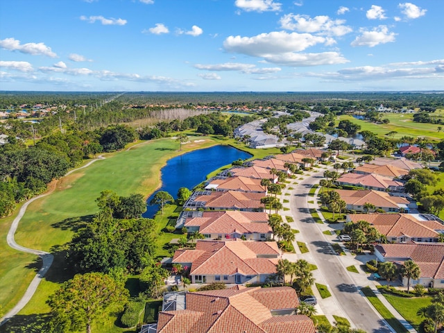aerial view with a residential view, view of golf course, and a water view