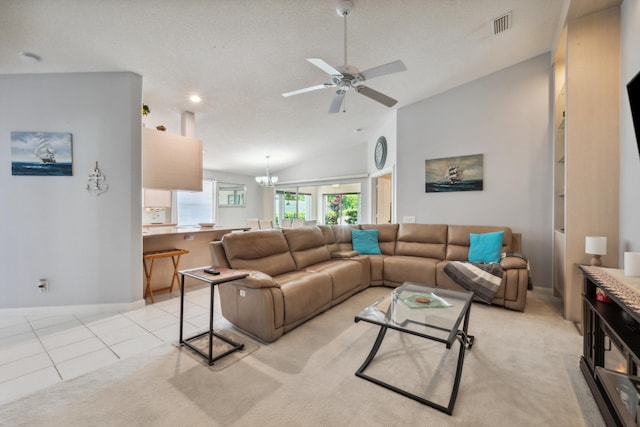 living room featuring light colored carpet, ceiling fan with notable chandelier, light tile patterned floors, lofted ceiling, and visible vents