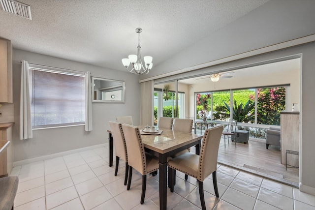 dining space featuring visible vents, a textured ceiling, and a healthy amount of sunlight