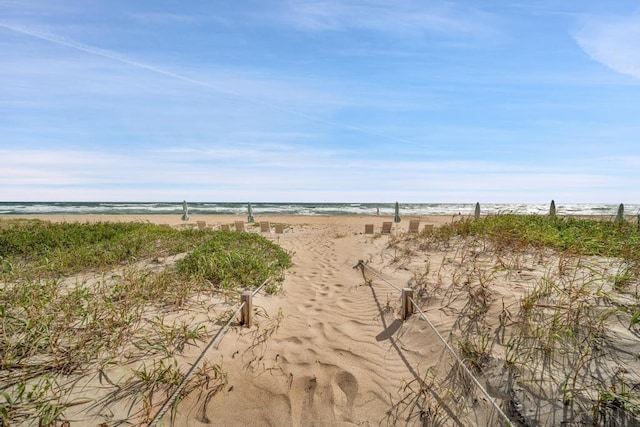 exterior space featuring a water view and a view of the beach