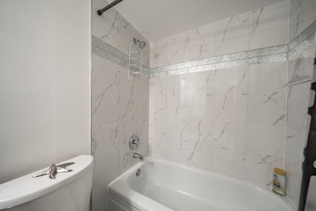 bathroom with shower / bathing tub combination and toilet