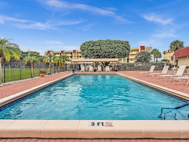 pool featuring a patio area and fence