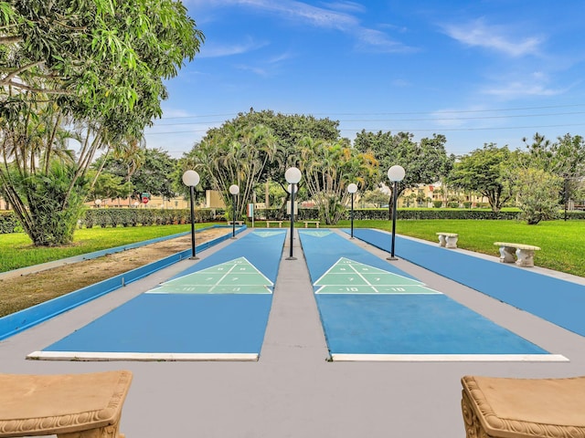view of home's community featuring a lawn and shuffleboard
