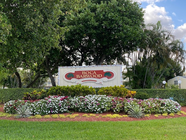 community / neighborhood sign with a lawn