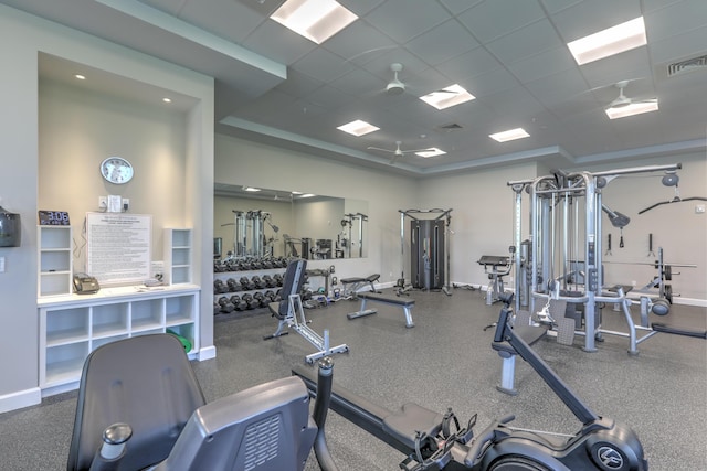 exercise room featuring baseboards, visible vents, and a paneled ceiling