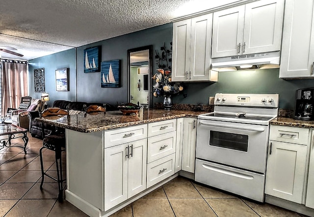 kitchen featuring tile patterned flooring, under cabinet range hood, white electric range, a peninsula, and open floor plan