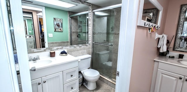 full bathroom featuring toilet, a stall shower, tile patterned flooring, and vanity