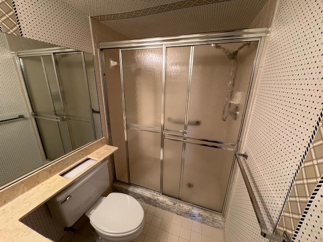 bathroom with toilet and a stall shower
