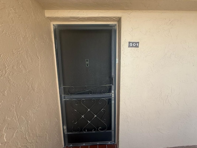 entrance to property with stucco siding