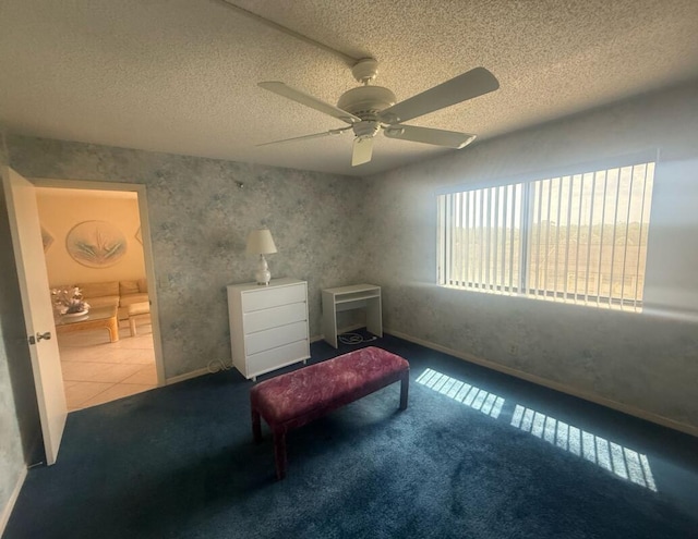 carpeted bedroom with a textured ceiling, ceiling fan, and baseboards