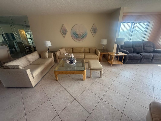 living room featuring a textured ceiling and light tile patterned flooring