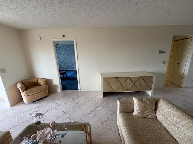 living room with light tile patterned floors and a textured ceiling