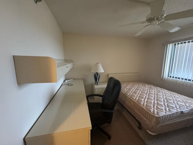 carpeted bedroom with a textured ceiling and ceiling fan