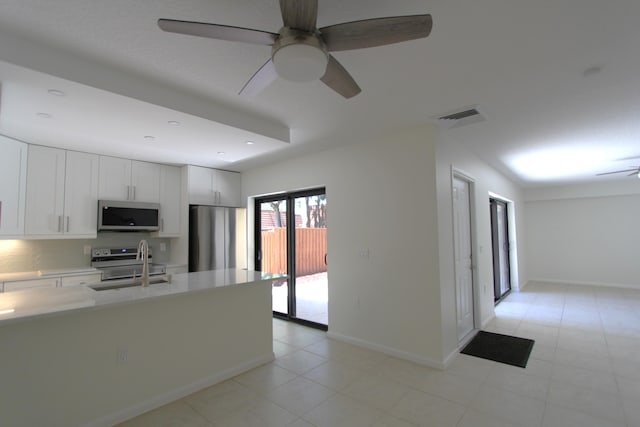 404 Live Oak Ln, Boynton Beach, FL 33436 - kitchen featuring appliances with stainless steel finishes, light countertops, ceiling fan, a sink, and visible vents