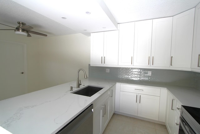 404 Live Oak Ln, Boynton Beach, FL 33436 - kitchen with white cabinets, a sink, appliances with stainless steel finishes, ceiling fan, and light stone countertops