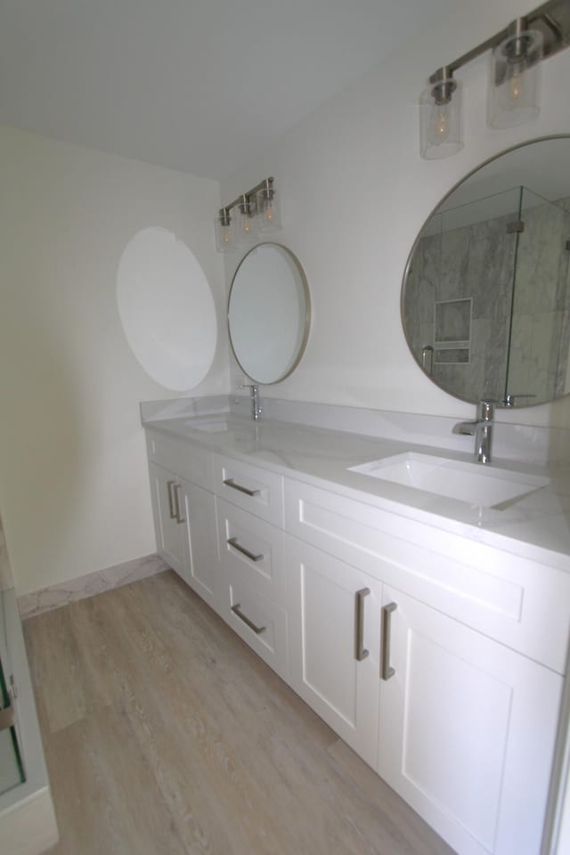 404 Live Oak Ln, Boynton Beach, FL 33436 - bathroom with wood finished floors, an enclosed shower, double vanity, and a sink