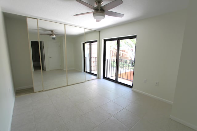 404 Live Oak Ln, Boynton Beach, FL 33436 - unfurnished bedroom featuring light tile patterned floors, a closet, access to exterior, ceiling fan, and baseboards