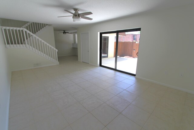 404 Live Oak Ln, Boynton Beach, FL 33436 - unfurnished living room with light tile patterned floors, stairs, ceiling fan, and baseboards