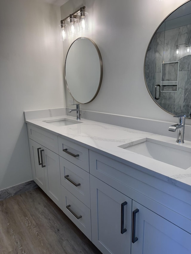 404 Live Oak Ln, Boynton Beach, FL 33436 - bathroom featuring double vanity and wood finished floors
