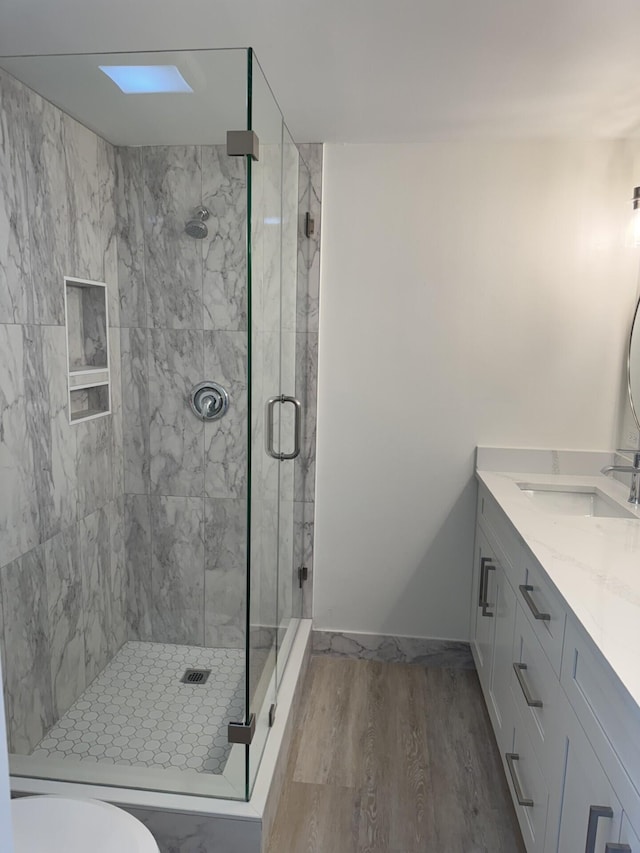 404 Live Oak Ln, Boynton Beach, FL 33436 - full bathroom featuring wood finished floors, vanity, and a shower stall
