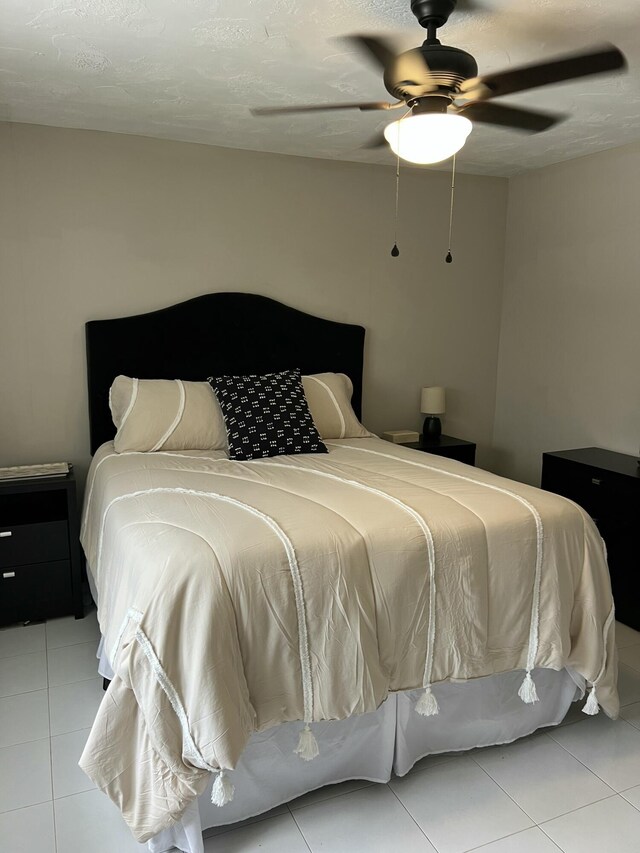 95 E E Ct, Royal Palm Beach, FL 33411 - tiled bedroom featuring a ceiling fan