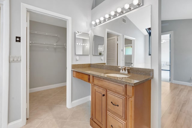 bathroom with vanity, baseboards, tile patterned floors, and visible vents