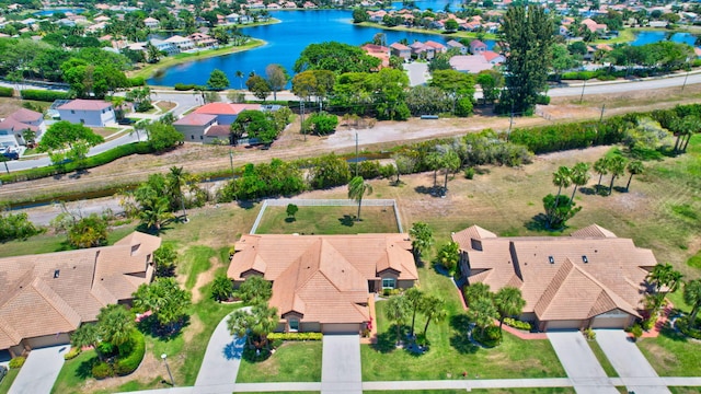 drone / aerial view featuring a water view and a residential view