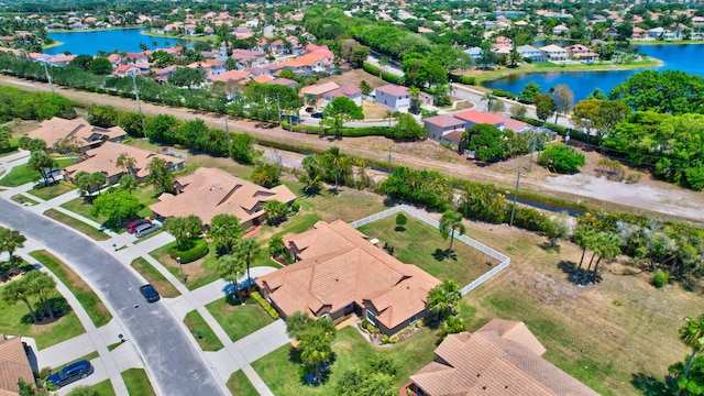 birds eye view of property with a water view and a residential view