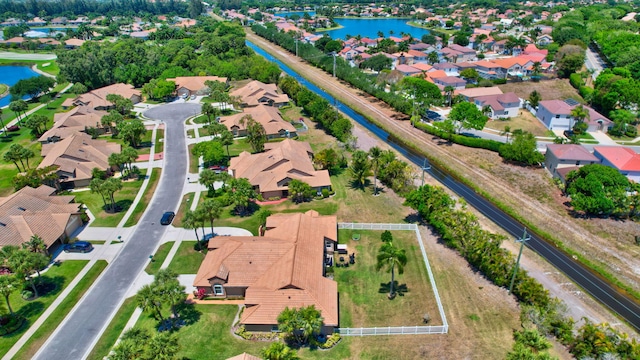 drone / aerial view featuring a water view and a residential view
