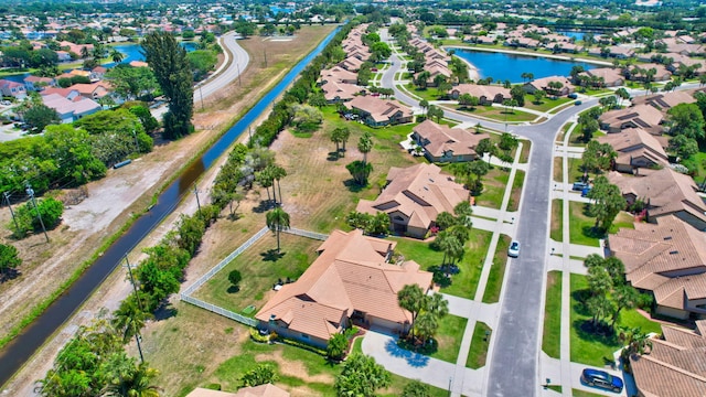 birds eye view of property featuring a water view and a residential view