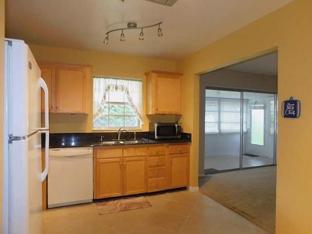 317 Colony Ln Unit A, Fort Pierce, FL 34982 - kitchen with white appliances, a sink, light brown cabinets, dark countertops, and light tile patterned floors