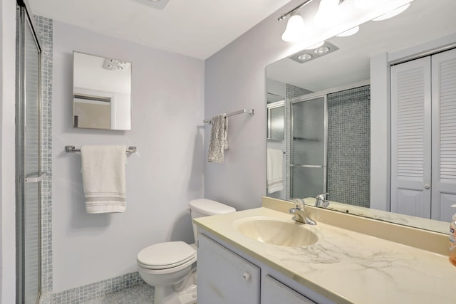 432 Grantham Unit B, Deerfield Beach, FL 33442 - bathroom featuring a stall shower, toilet, vanity, tile patterned floors, and a closet